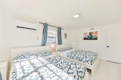 a bedroom with two beds and a window at Oasis of Love and Joy Family in Miami