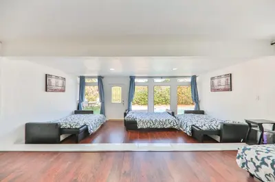a bedroom with two beds and two chairs at Oasis of Love and Joy Family in Miami