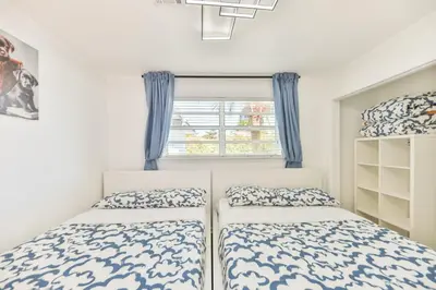a bedroom with two beds and a window at Oasis of Love and Joy Family in Miami