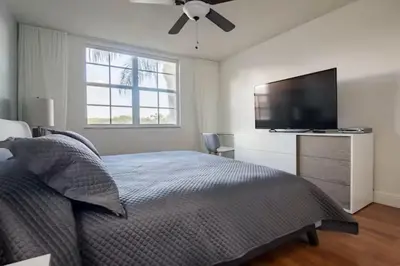 a bedroom with a bed and a flat screen tv at The Yacht Club at Aventura Miami 6307 in South Island