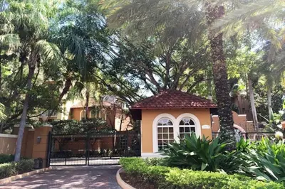 a small house with a gate and palm trees at The Yacht Club at Aventura Miami 6307 in South Island