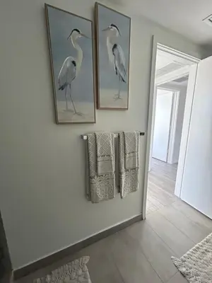 a bathroom with three framed drawings of birds on the wall at Miami-Brickell Skyline Luxury High Rise 2BR-2BATH - walking distance to KASEYA - HEAT ARENA - BAYSIDE - PORT OF MIAMI CRUISE SHIPS in Miami