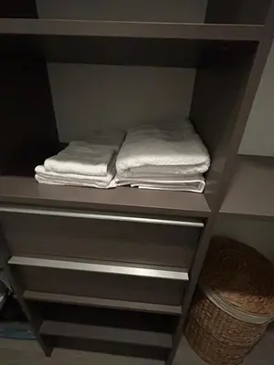 a shelf with folded towels in a closet at Miami-Brickell Skyline Luxury High Rise 2BR-2BATH - walking distance to KASEYA - HEAT ARENA - BAYSIDE - PORT OF MIAMI CRUISE SHIPS in Miami