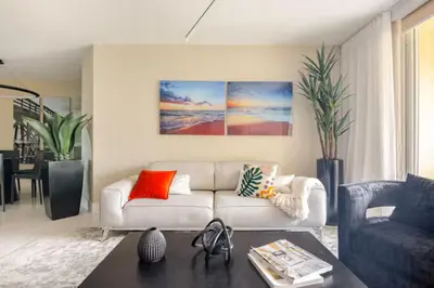 a living room with a white couch and a table at The Yacht Club at Aventura Miami 9505 in South Island