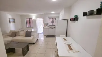 a living room with a couch and a table at Apartment close to shops & beach-Free Parking 109 in Hollywood