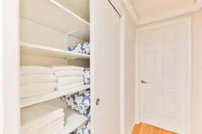 a closet with white towels and a door at Heart of Hollywood Villa in Hollywood
