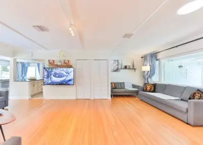 a living room with a couch and a tv at Heart of Hollywood Villa in Hollywood