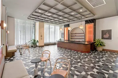 a lobby with a waiting area with chairs and tables at Stylish 1BR Apt With Pool in Miami