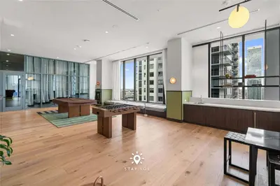 a large room with a table and some windows at Stylish 1BR Apt With Pool in Miami