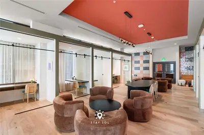 a lobby with chairs and a table in a building at Stylish 1BR Apt With Pool in Miami