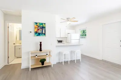 a kitchen with white walls and a ceiling fan at Modern 2BR Stay with Desk, Patio, BBQ, Free Parking in Fort Lauderdale