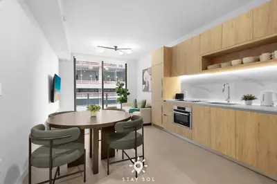 a kitchen and dining room with a table and chairs at Stylish City Retreat With Private Balcony in Miami