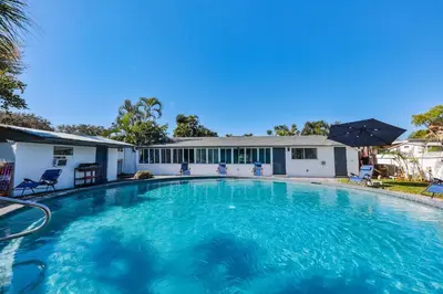 a large swimming pool in front of a house at 50 Shades of Grey on the Canal Villa STR-4500 in Fort Lauderdale