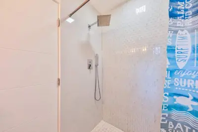 a shower with a glass door in a bathroom at 50 Shades of Grey on the Canal Villa STR-4500 in Fort Lauderdale
