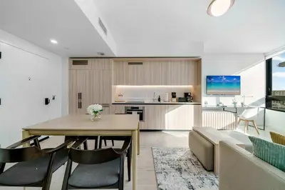 a kitchen and living room with a table and chairs at Downtown Edit-Resort Style Stay with Full Amenities in Miami