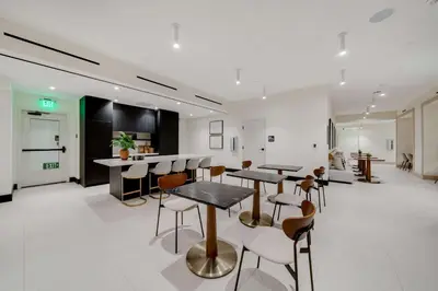 a room with tables and chairs and a kitchen at Downtown Edit-Resort Style Stay with Full Amenities in Miami