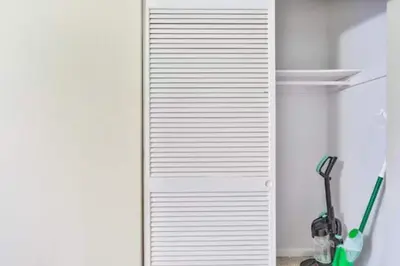 a closet with a white door with a vacuum at Dream Beach Room Free Parking - 02227 in Sunny Isles Beach