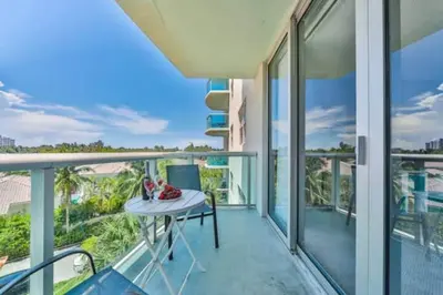 a balcony with a table and a view of the ocean at Dream Beach Room Free Parking - 02227 in Sunny Isles Beach