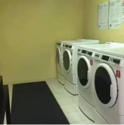 a laundry room with two washing machines in it at Dream Beach Room Free Parking - 02227 in Sunny Isles Beach