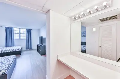 a room with a mirror and a bedroom with a bed at Coastal Elegance Oasis in Sunny Isles STR-01308 in Sunny Isles Beach