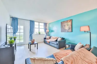 a living room with blue walls and a couch at Coastal Elegance Oasis in Sunny Isles STR-01308 in Sunny Isles Beach