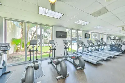 a gym with rows of treadmills and elliptical machines at Condo with Stunning View STR-01307 in Sunny Isles Beach