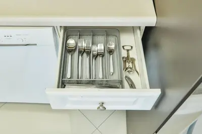 a drawer with forks and spoons in a cabinet at Family getaway steps from the ocean STR-01305 in Sunny Isles Beach