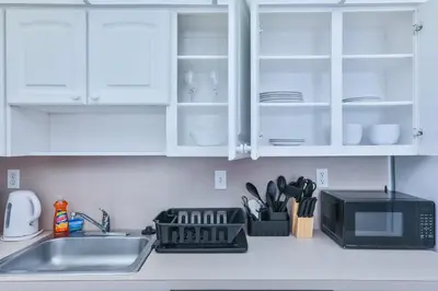 a kitchen counter with a sink and a microwave at Ocean reserve 1st floor across the beach STR-02382 in Sunny Isles Beach