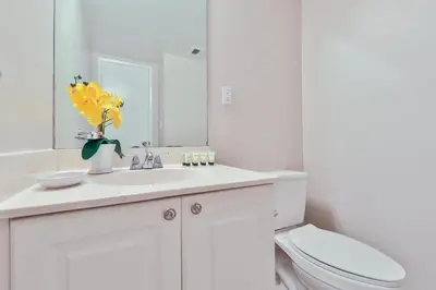 a bathroom with a sink and a toilet and a mirror at Ocean reserve 1st floor across the beach STR-02382 in Sunny Isles Beach