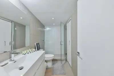 a white bathroom with a sink and a toilet at Ocean Vista in Sunny Isles Beach