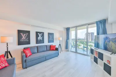 a living room with a couch and a tv at Ocean Vista in Sunny Isles Beach