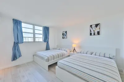 a bedroom with two beds and a window at Ocean Vista in Sunny Isles Beach