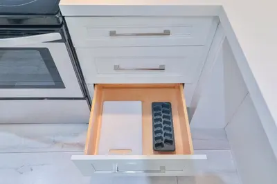 a drawer in a kitchen with a remote control in it at Ocean Vista in Sunny Isles Beach
