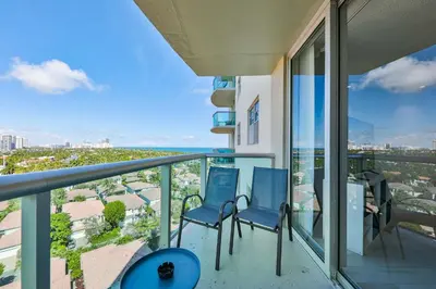 two chairs on a balcony with a view of the ocean at Ocean Vista in Sunny Isles Beach