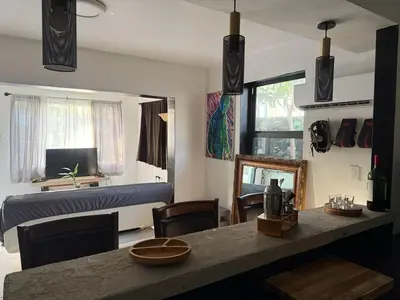 a living room with a couch and a table with chairs at paradise in North Miami Beach