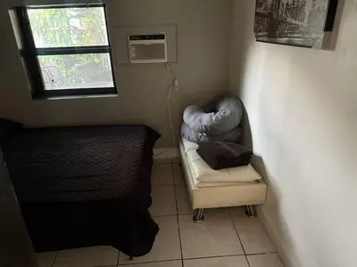 a small room with a chair and a window at paradise in North Miami Beach