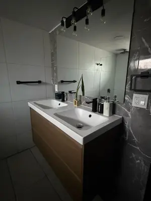 a bathroom with a white sink and a mirror at paradise in North Miami Beach