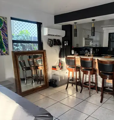 a kitchen with a mirror and some bar stools at paradise in North Miami Beach