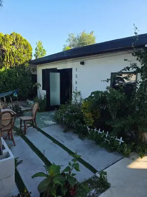 a house with a patio with a table and chairs at paradise in North Miami Beach
