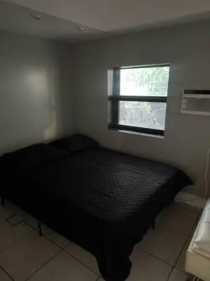 a bed in a bedroom with a window at paradise in North Miami Beach