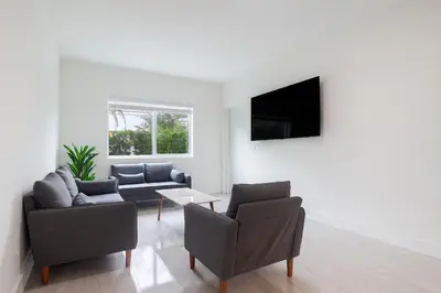 a living room with two couches and a tv at 3BR Getaway, 4 Beds, Near Beach, Free Parking in Hallandale Beach