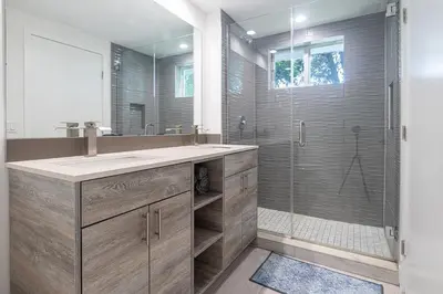 a bathroom with a sink and a glass shower at 3BR Getaway, 4 Beds, Near Beach, Free Parking in Hallandale Beach