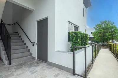 a house with a staircase and a door at 3BR Getaway, 4 Beds, Near Beach, Free Parking in Hallandale Beach