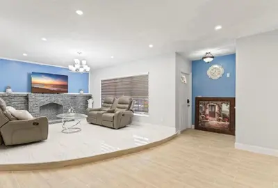a living room with two chairs and a fireplace at Private King Master Suite Near Hardrock Stadium in Miami Gardens