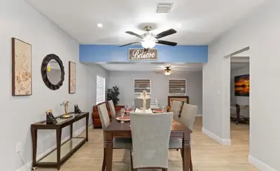 a dining room with a table and a ceiling fan at Private King Master Suite Near Hardrock Stadium in Miami Gardens