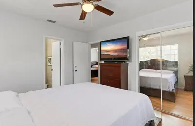 a bedroom with a bed and a flat screen tv at Private King Master Suite Near Hardrock Stadium in Miami Gardens