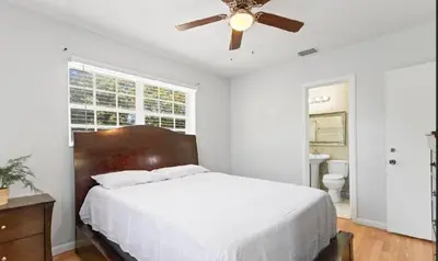 a bedroom with a bed and a ceiling fan at Private King Master Suite Near Hardrock Stadium in Miami Gardens