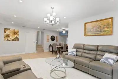 a living room with a couch and a table at Private King Master Suite Near Hardrock Stadium in Miami Gardens