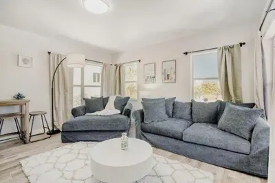 a living room with two couches and a table at Lauderdale Breeze Villas - Coastal 2 Bedroom in Fort Lauderdale
