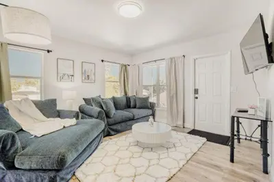 a living room with a couch and a table at Lauderdale Breeze Villas - Coastal 2 Bedroom in Fort Lauderdale